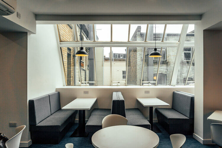Booth seating and tables under the glazed roof at Coppergate House